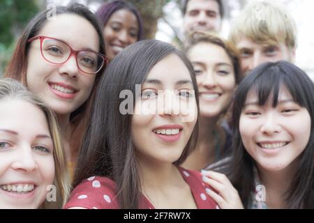 Group of happy smiling friends making a selfie in the park.  Friendship, tourism, travel, people, leisure and technology concept. Stock Photo