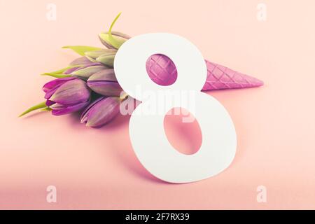 8 March, International Women's Day. Number eight with pink tulips on pink background. Greeting card. Copy space. Stock Photo