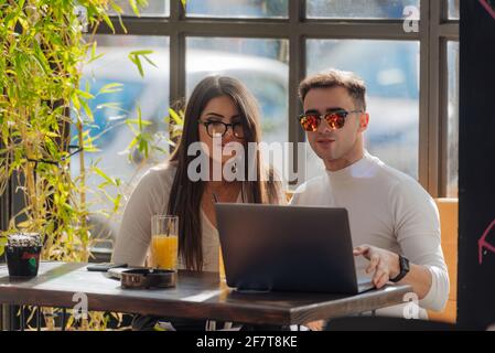 Co-workers spending time together on a break while working on a project on a lovely sunny day. Stock Photo
