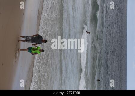 salvador, bahia / brazil - may 30, 2017: Couple is seen walking on Barra beach in the city of Salvador. *** Local Caption ***  . Stock Photo