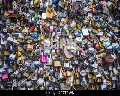 Full frame of padlocks attached to chain link fence, San Antonio, TX Stock Photo