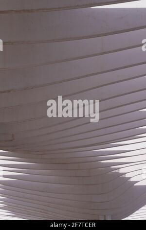 Shadows in the shape of waves in a modern white cement canopy Stock Photo
