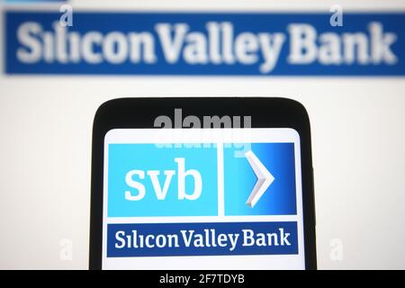 In this photo illustration the Silicon Valley Bank (SVB) logo is seen on a smartphone and a pc screen. Stock Photo