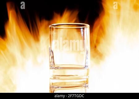 glass glass on fire on a black background Stock Photo