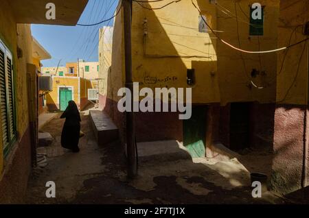 ASWAN, EGYPT - Jan 10, 2013: Aswan, Egypt. 10th January 2013  A local Muslim women walking in the narrow alleyways of a Nubian Village on Elephantine Stock Photo