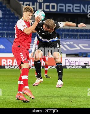 Bielefeld, Germany. 9th Apr, 2021. Yannik Keitel (L) of Freiburg vies for header with Fabian Klos of Bielefeld during a German Bundesliga match between Arminia Bielefeld and SC Freiburg in Bielefeld, Germany, April 9, 2021. Credit: Ulrich Hufnagel/Xinhua/Alamy Live News Stock Photo