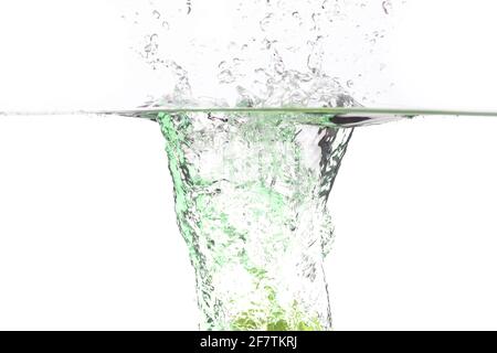 juicy green apple falls into the water on a white background, place under the text Stock Photo