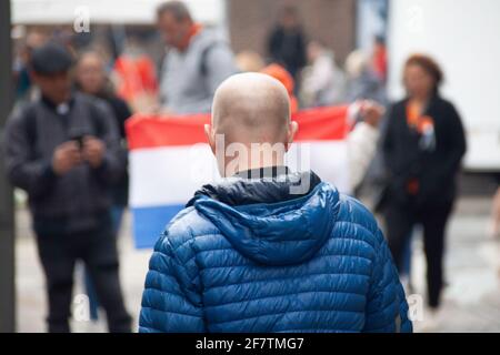 Amsterdam, The Netherlands - April 27, 2019: Man with Dutch in the background. Stock Photo