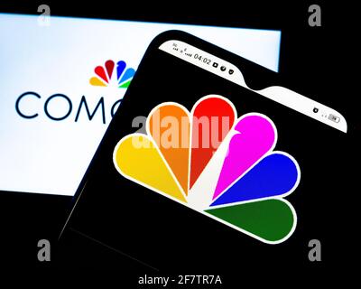 In this photo illustration Comcast Corporation logo seen displayed on a smartphones Stock Photo