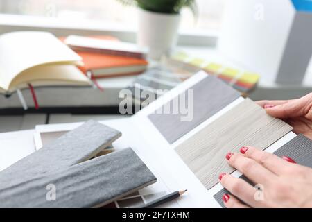 Woman choosing color of laminate board in design studio closeup Stock Photo