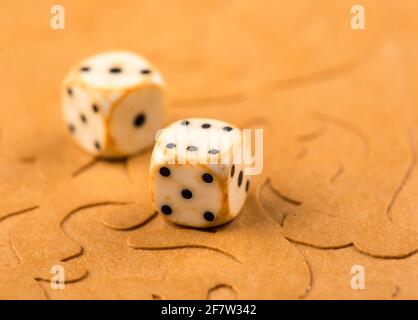 Cubes and game pieces on a backgammon board Stock Photo