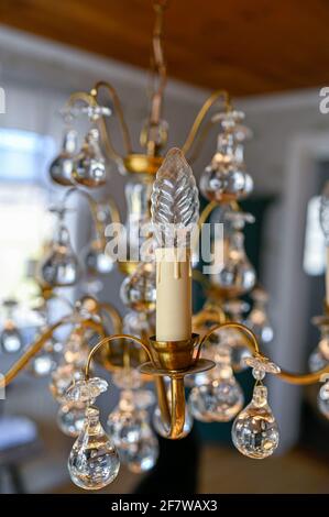 old crystal chandelier hanging from ceiling in retro home Stock Photo