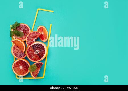 A glass made of red orranges and on colorful background. Minimalism design concept. Top view, copy space Stock Photo
