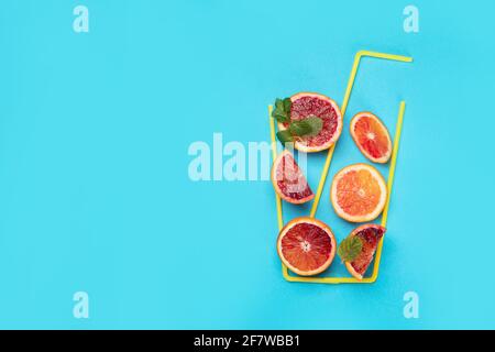 A glass made of red orranges and on colorful background. Minimalism design concept. Top view, copy space Stock Photo