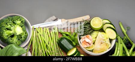Set of various green vegetables and fruits like cabbage, broccoli, asparagus, peas, Brussels sprouts, zucchini, peppers, garlic, beans, pak choy, lime Stock Photo