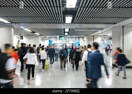 People going to work, walking inside MTR station / subway train station in Hong Kong - Stock Photo