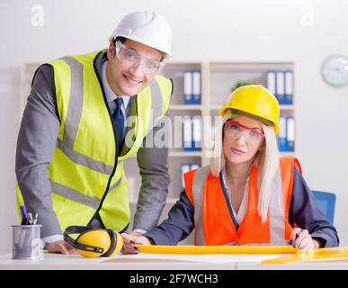 Construction workers having discussion in office before starting project Stock Photo