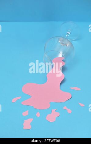 Abstract Overturned Glass Of Spilled Rose Wine Stock Photo