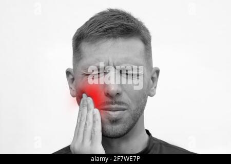 Closeup of man face with strong tooth pain. Man suffering from toothache or feeling tooth pain Stock Photo