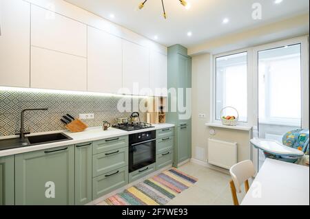Cozy modern kitchen interior, some drawers pulled out Stock Photo