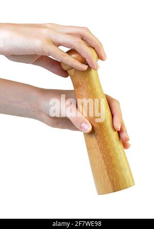 Wooden pepper mill in hands isolated on white background. Stock Photo
