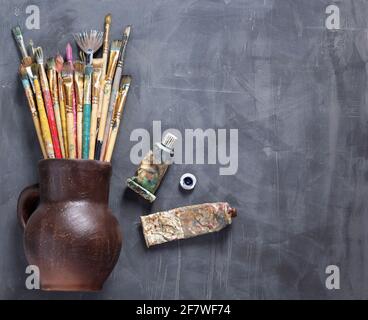 Paint brush and tubes on abstract table background texture. Art painter tools concept Stock Photo