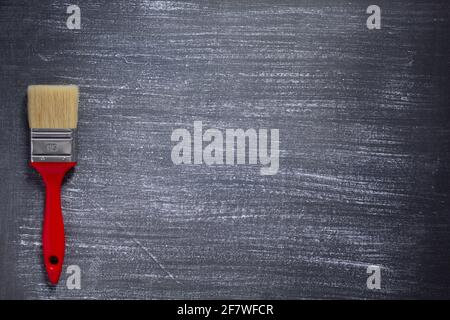 Painted background texture and paintbrush as abstract surface. Painted dark grey or black background canvas Stock Photo