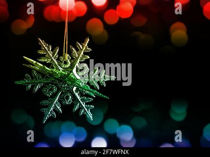 Christmas decoration in the shape snowflake on black background. Stock Photo