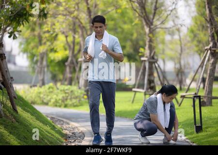 Senior Couple Running, Mature jogging outdoors in natural environment on summer morning Stock Photo