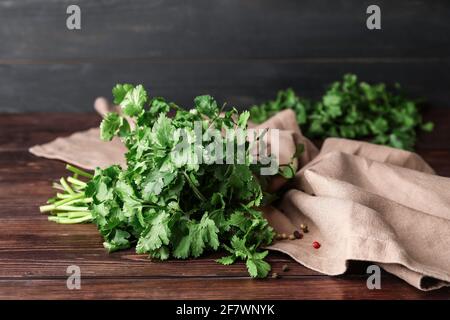 Fresh cilantro on wooden background