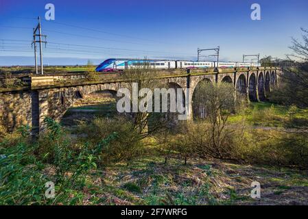 A train crossing the Sankey viaduct at Earlestown over the Sankey Valley.It is the earliest major railway viaduct in the world. Stock Photo