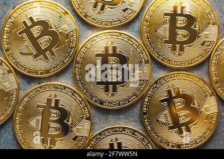 Close up shot of some bitcoins on a textured background. Golden BTC coins, Stock Market of cryptocurrencies and decentralized finances concept Stock Photo