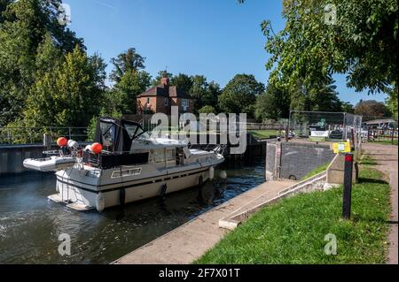 A river cruiser approaching Temple Lock, between Hurley and Marlow on the River Thames in Buckinghamshire, Britain. Stock Photo