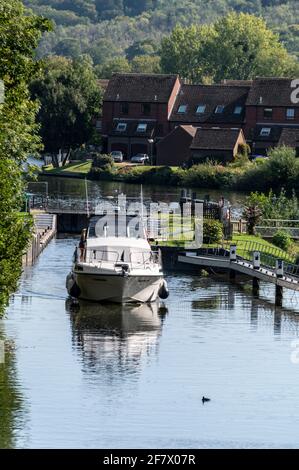 A river cruiser leaving Temple Lock, between Hurley and Marlow on the River Thames in Buckinghamshire, Britain. Stock Photo