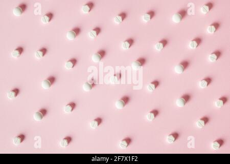 Top view white pills on pink background Stock Photo