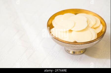 Silver chalice cup and Sacramental bread, or Hosties, symbolising the