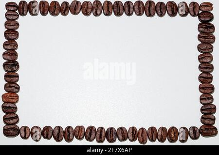 rectangular frame of black coffee beans photographed on white background close-up Stock Photo