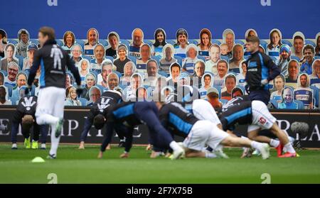 London, England, 10th April 2021. QPR players warm up in front of pictures of their fans before the Sky Bet Championship match at the The Kiyan Prince Foundation Stadium, London. Picture credit should read: David Klein / Sportimage Credit: Sportimage/Alamy Live News Stock Photo
