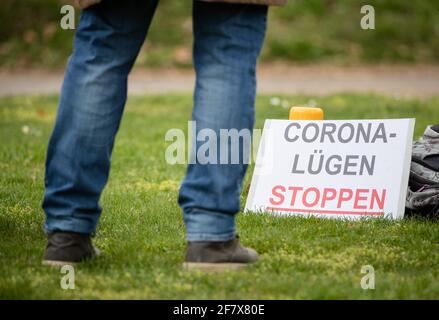 10 April 2021, Baden-Wuerttemberg, Heilbronn: 'Stop Corona lies' is written on the sign of a participant of a demonstration of the initiative 'Querdenken'. The demonstration is directed against the pandemic restrictions of the federal government. Photo: Christoph Schmidt/dpa Stock Photo