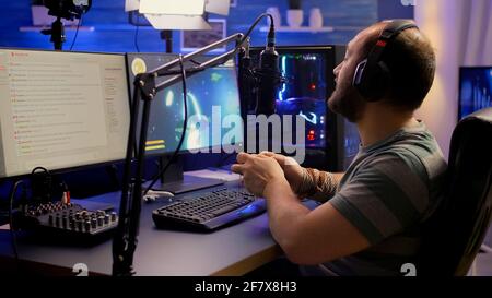 Premium Photo  Streamer man talking with multiple players into headphones  and winning video games competition. professional gamer streaming online  videogames with new graphics on powerful computer from gaming room