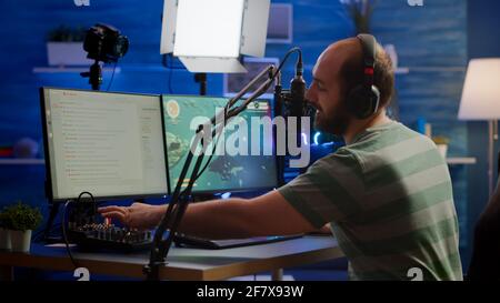 Premium Photo  Streamer man talking with multiple players into headphones  and winning video games competition. professional gamer streaming online  videogames with new graphics on powerful computer from gaming room