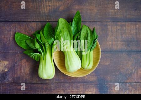 A bamboo plate with fresh Chinese 'pak choi' cabbage. Stock Photo