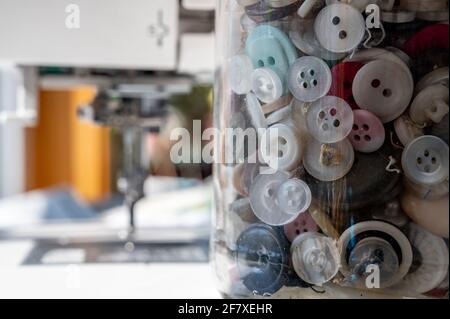 various types of buttons stored in a glass container Stock Photo