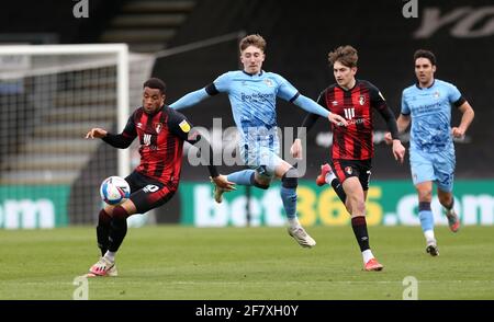 Coventry City's Josh Eccles (centre) and AFC Bournemouth's Arnaut Danjuma (left) battle for the ball during the Sky Bet Championship match at the Vitality Stadium, Bournemouth. Picture date: Saturday April 10, 2021. Stock Photo