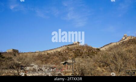 The great wall of China laying on mountains under blue sky. Stock Photo