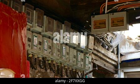 Old style electric meters hanging on the wall. Stock Photo