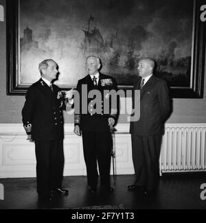 The British Commander-in-Chief Home Fleet Admiral Sir William Davis (1901-1987, Middle) visited the Minister of Marine Ir. C. Staff (1905-1973, on the right) and the commander of marine workers (BDZ) in 1958 Vice-Admiral HHL Pröpper (1906-1995, left) at the Ministry of Marine in The Hague. Stock Photo