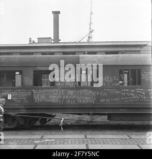 A train carriage with calcisted inscriptions of soldiers from the 1st division 'December 7'. They went with the MS 'Tegelberg' from Amsterdam to the Dutch East Indies. Stock Photo