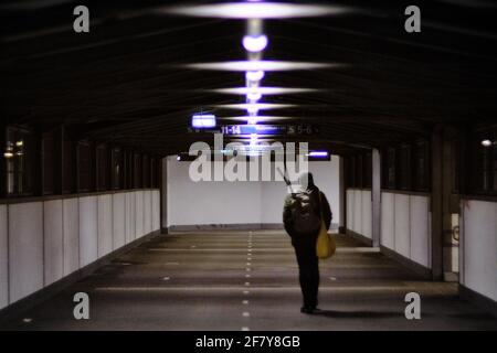 Man crosses covered pedestrian bridge across the Bellmouth Passage, a ...