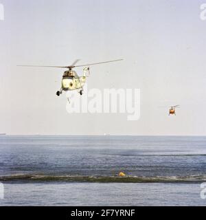 The Sikorsky HSS-1N (SH-34J, UH-34J) submarine control helicopter 142 (1960-1972) with an Andrere helicopter in the background. Stock Photo